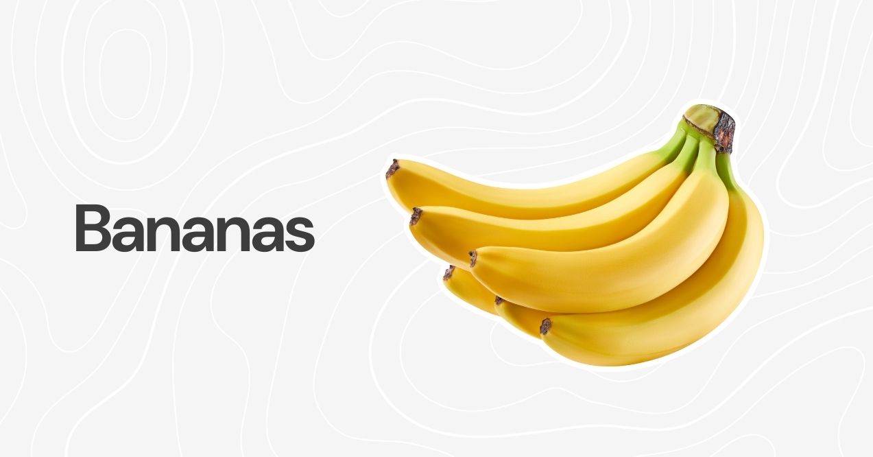 A bunch of ripe yellow bananas against a neutral background.