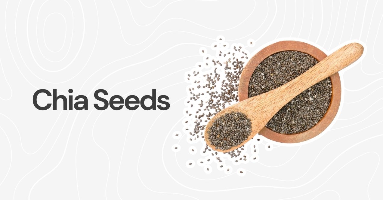 A wooden spoon and bowl filled with black chia seeds against a neutral background.