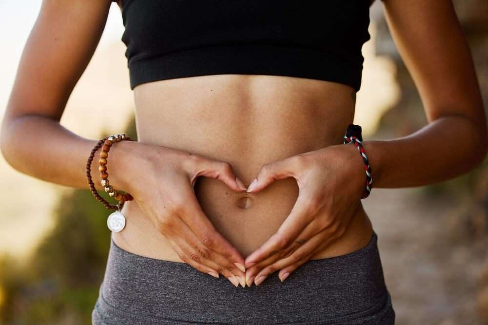 Woman showing sign for gut health