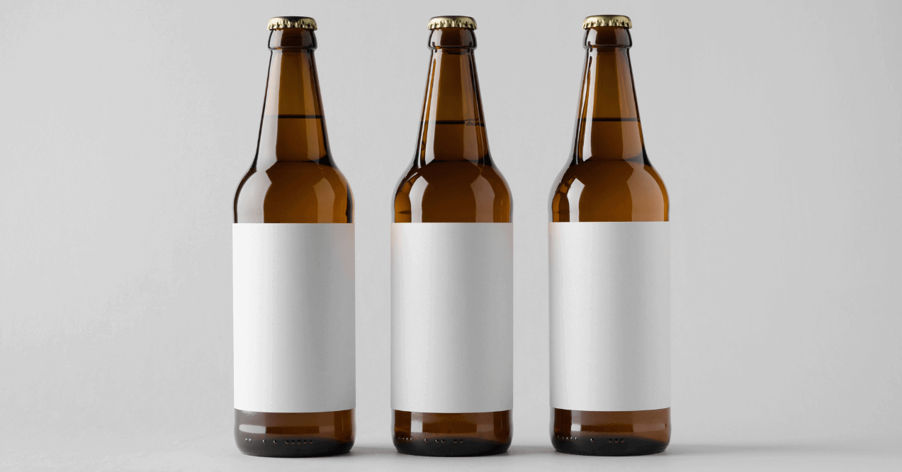 Three glass bottles of unnamed beers in white background