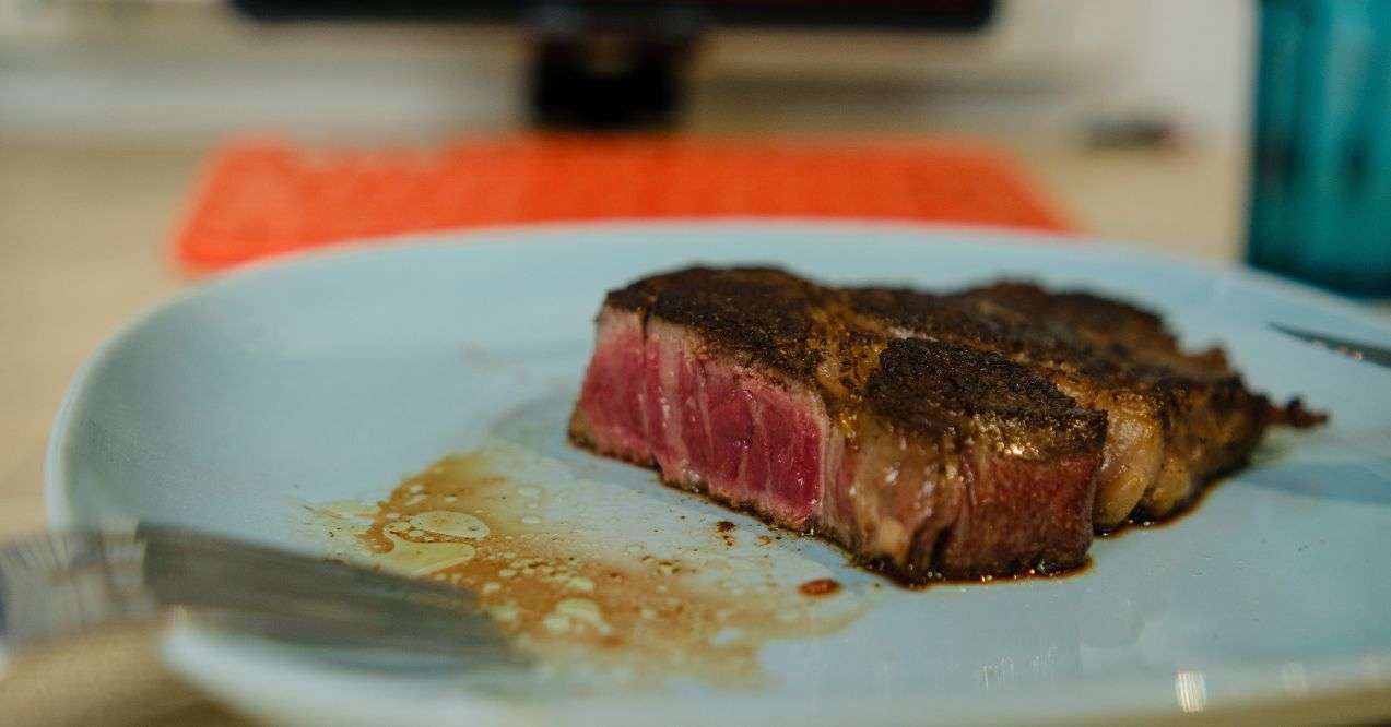 Zoomed in steak cut open on a white plate