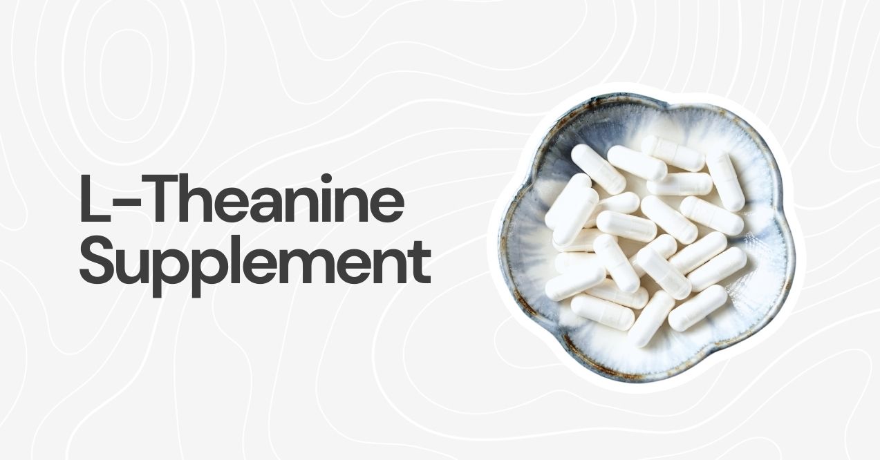 White capsules of L-Theanine in a ceramic bowl on a white background.