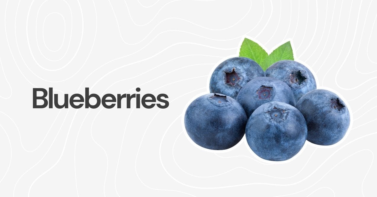 Ripe blueberries with a green leaf on a light background.