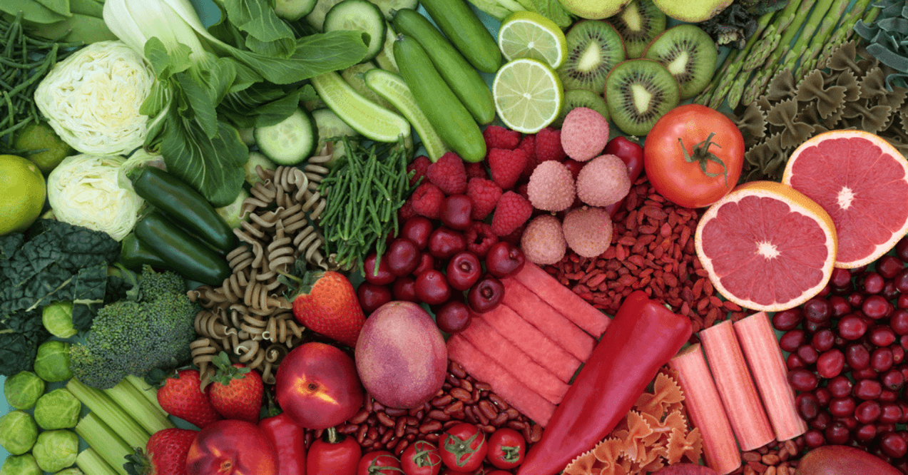 Red and green high fibre food for gut health concept with fruit, vegetables, pasta and legumes with super foods also high in antioxidants, smart carbs, anthocyanins, lycopene , minerals and vitamins.