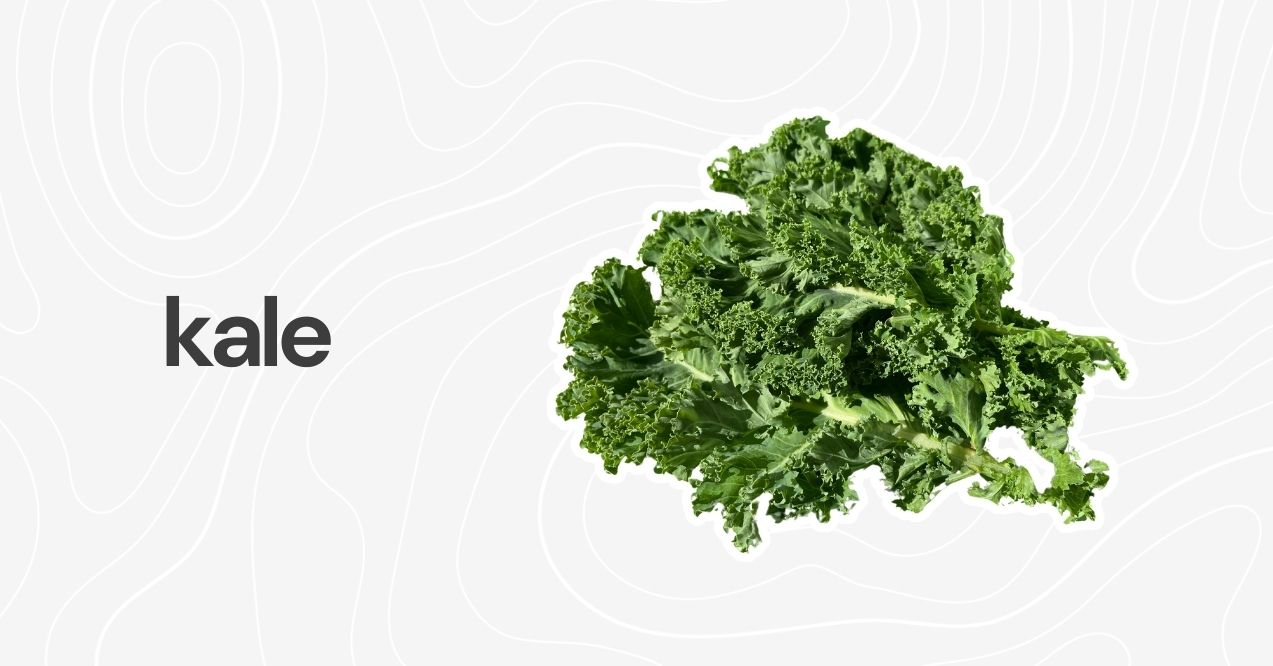 Fresh green kale leaves on a light background.