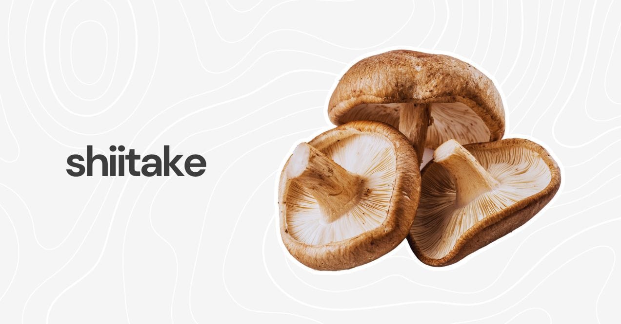 Close-up of fresh shiitake mushrooms with brown caps and white gills on a light background.