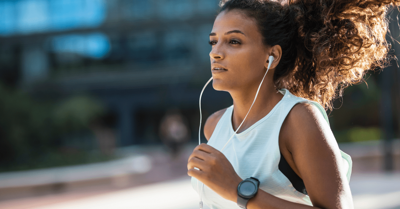 Woman with white headphones going for a run