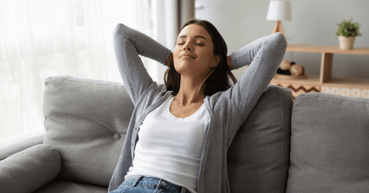 Woman taking a mental break and relaxing on a sofa