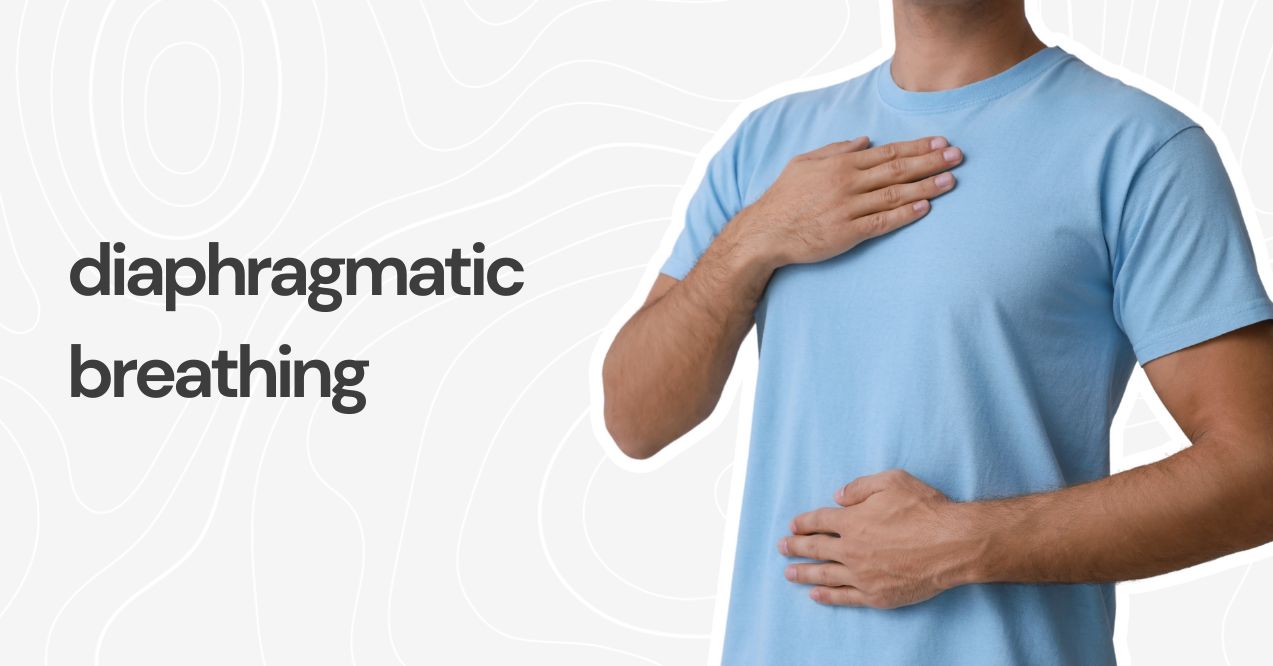 A person wearing a blue shirt practicing diaphragmatic breathing with one hand on their chest.