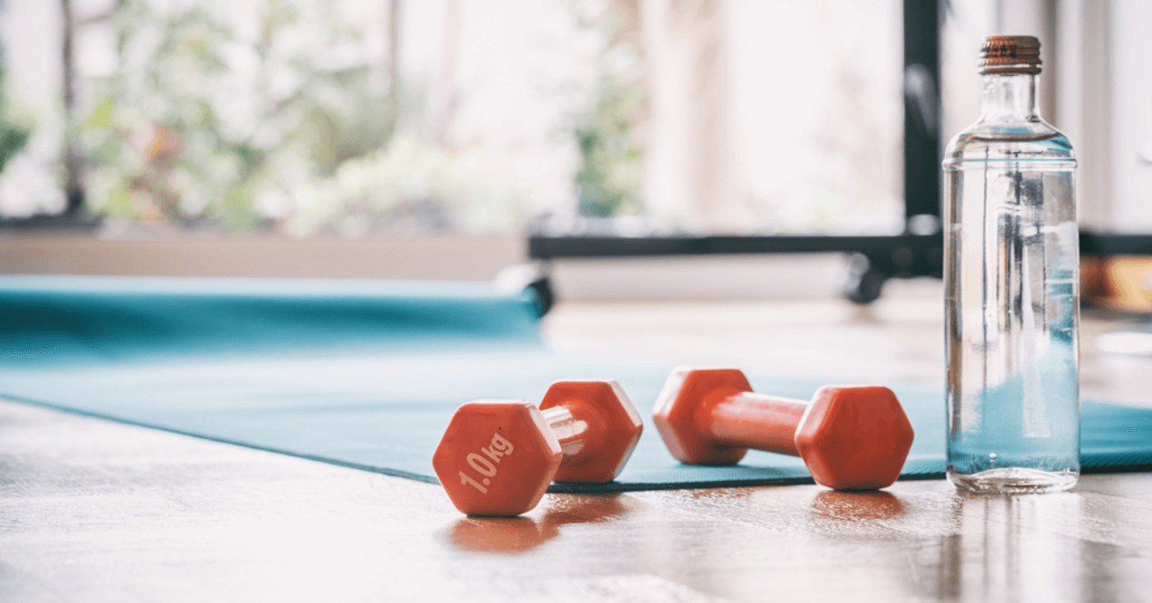 Red Dumbels and a Blue Yoga Mat in the Background