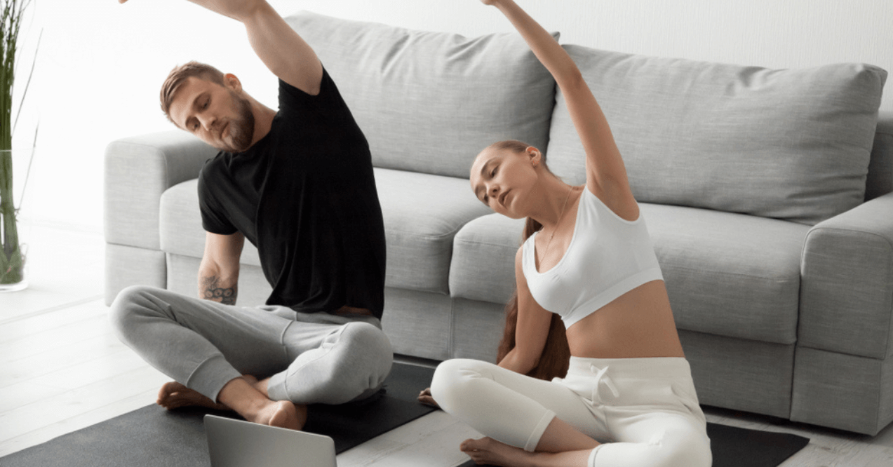 Young Couple Doing a Somatic Workout from The Computer