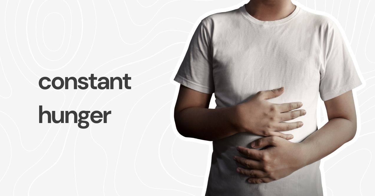 A person holding their stomach, symbolizing constant hunger.