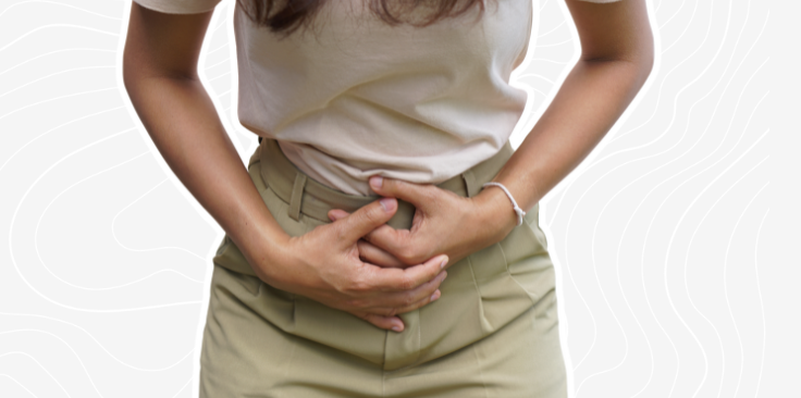 women holding her belly due to ovulation on the grey custom background