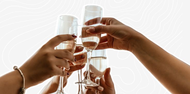 hands holding champagne glasses cut off on the grey custom background