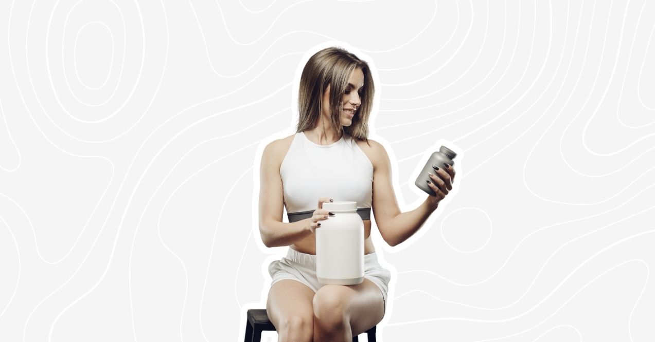 Young woman in white tank top holding two supplement bottles.