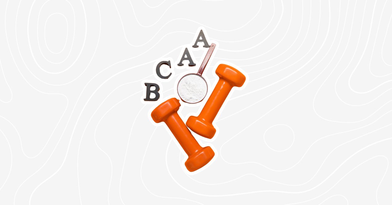 Orange dumbbells with a scoop of powdered BCAAs placed next to letters B, C, and A on a light background.