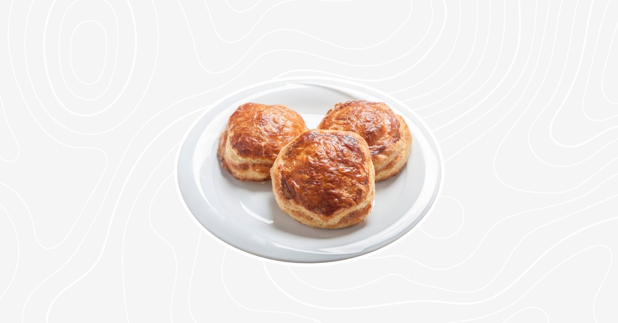 Three golden coffee buns on a white plate.