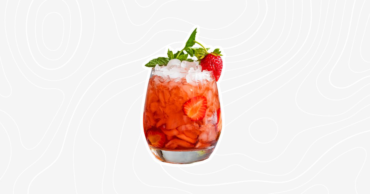 A strawberry mojito mocktail garnished with fresh mint leaves and strawberry slices.