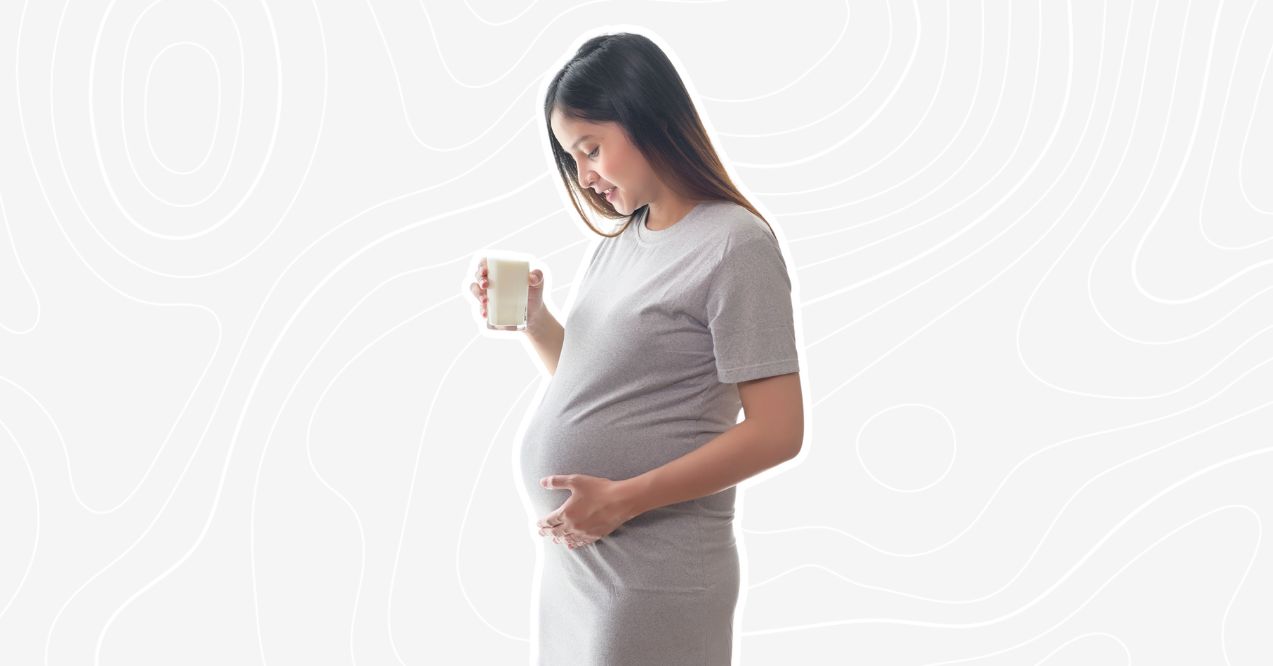 Can You Take Pre Workout While Pregnant: Pregnant woman holding a drink, symbolizing a healthy lifestyle.