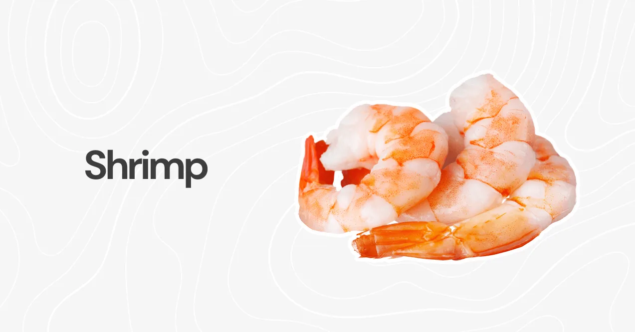 Cooked shrimp with a pink-orange hue, arranged on a white background with a subtle pattern.