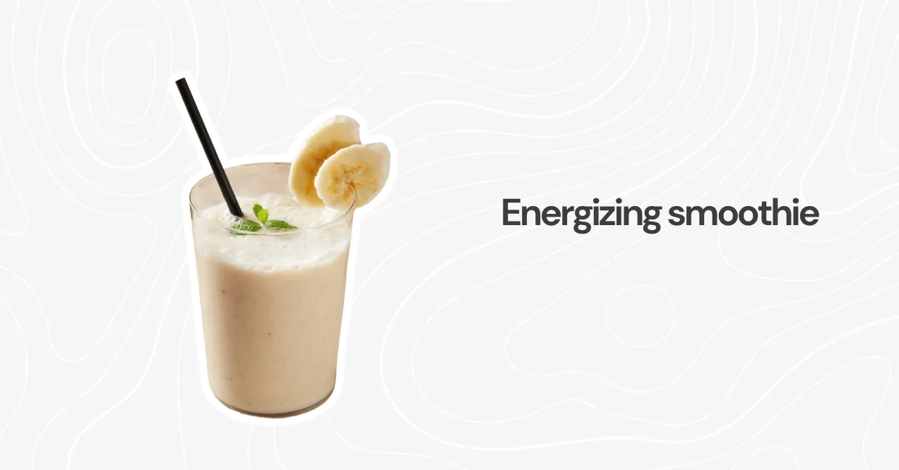 A glass of banana protein smoothie with a straw and banana slices, offering a refreshing and nutritious energy boost.