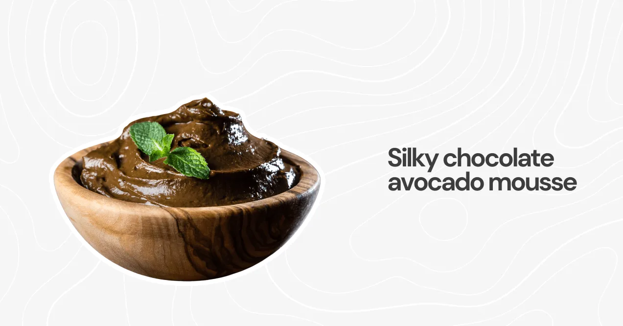 A bowl of creamy chocolate avocado mousse garnished with fresh mint, a healthy and indulgent high-protein dessert.
