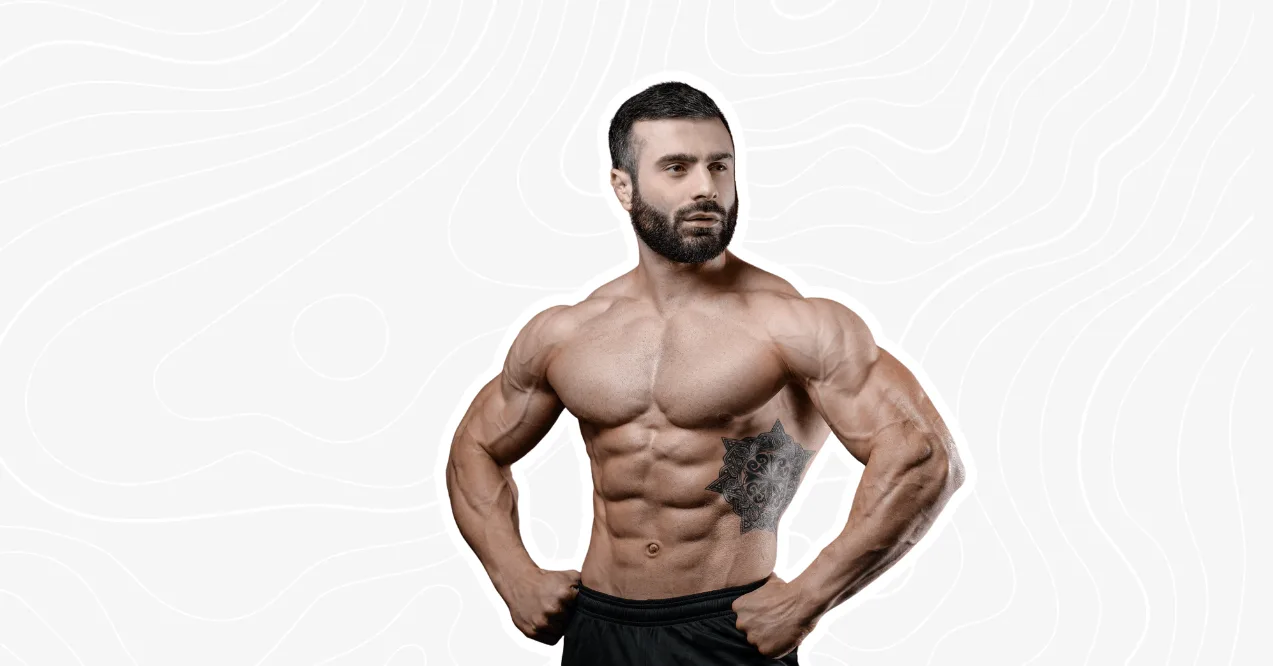 A muscular man flexing his muscles, showcasing a strong physique and tattoos on his torso.