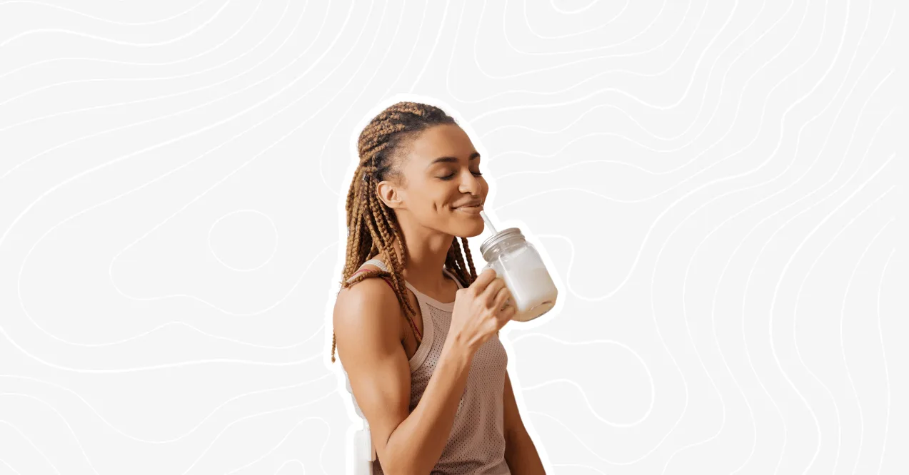 Woman enjoying a pre-workout drink, preparing for an energizing workout.